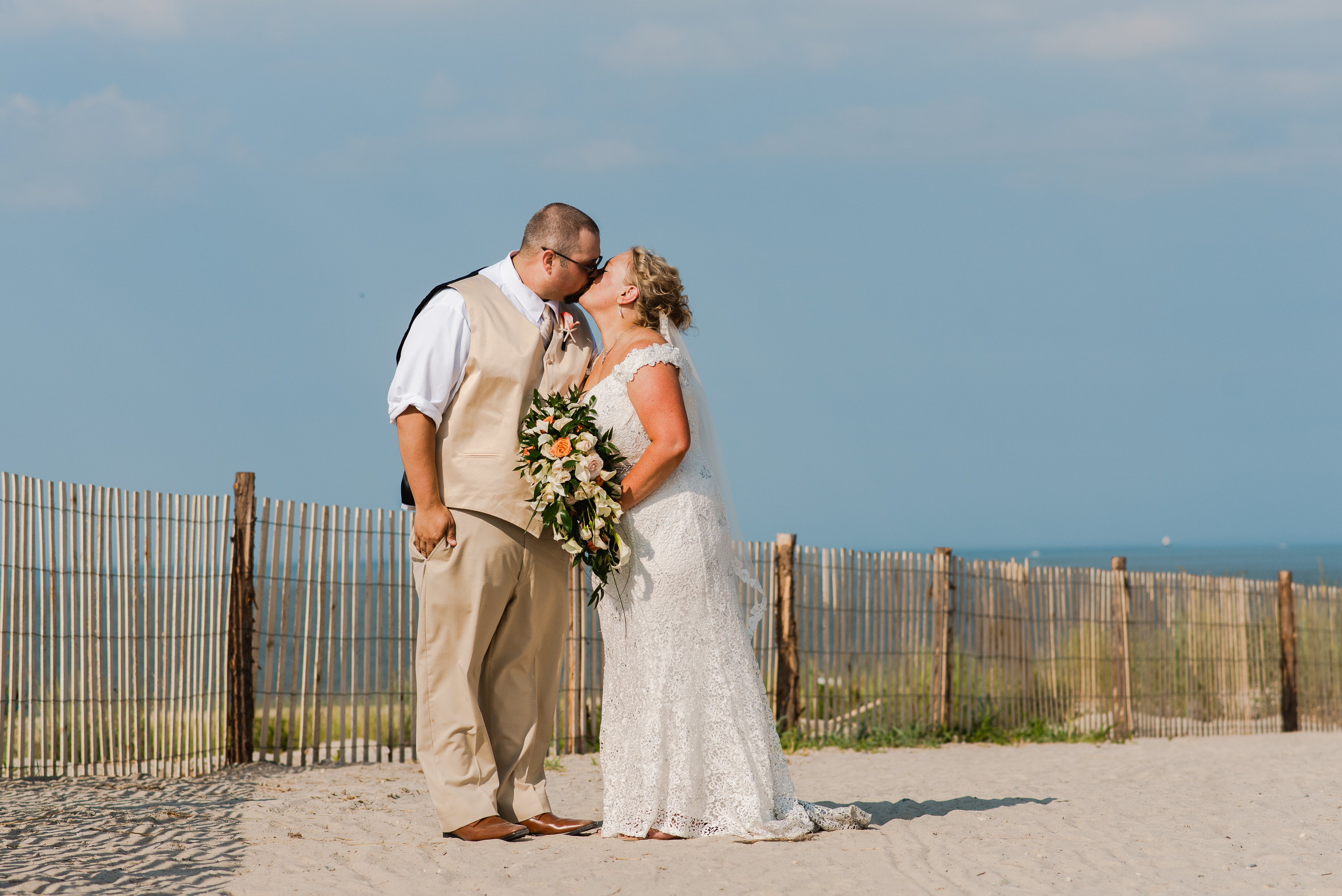 Wedding couple kissing on a beach in Lewes, Delaware
