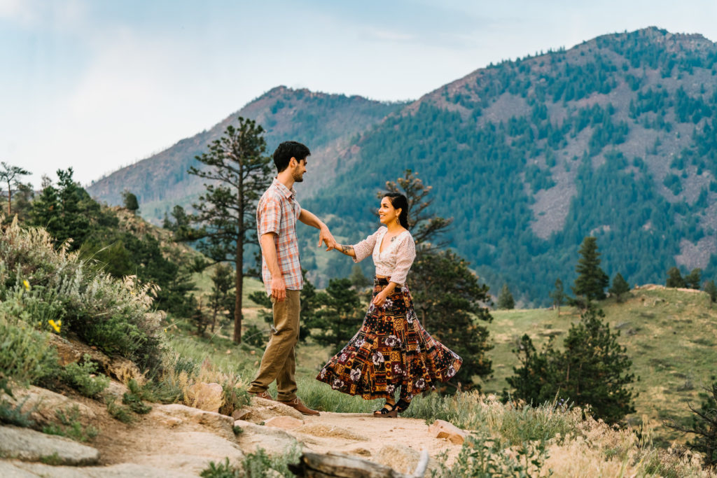 A couple dancing at sunset with the mountains behind them in Boulder, Colorado